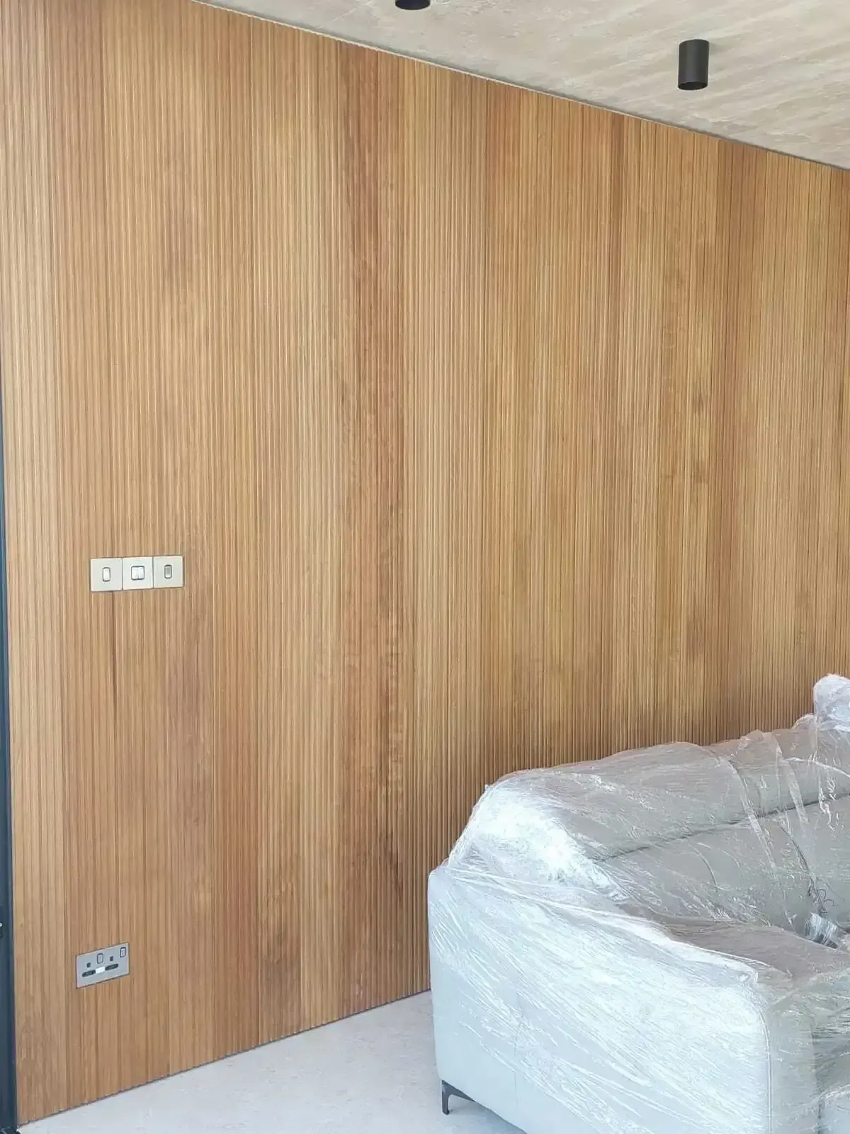 Fluted wood panelling running floor to ceiling in the living room
