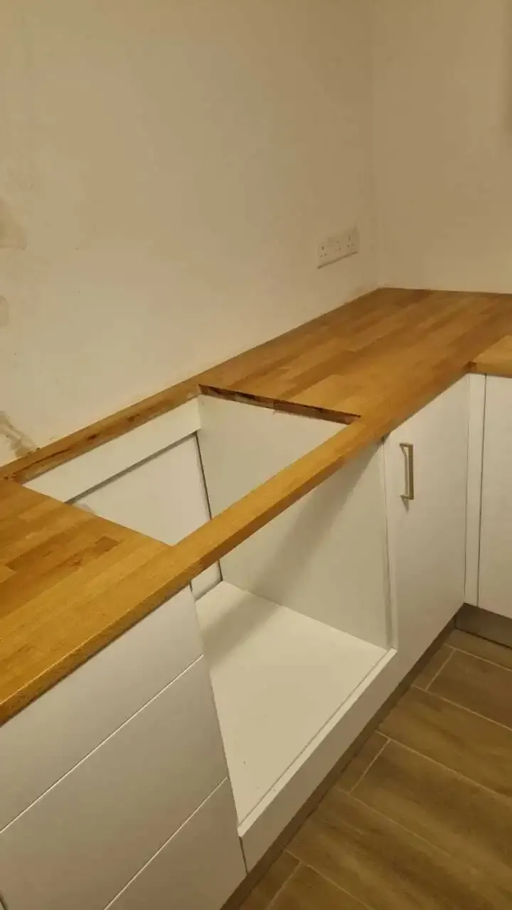Solid wood worktop cut and fitted around the hob opening