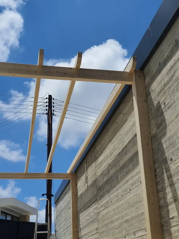 Timber frame of the pergola during construction, before the canopy was fitted