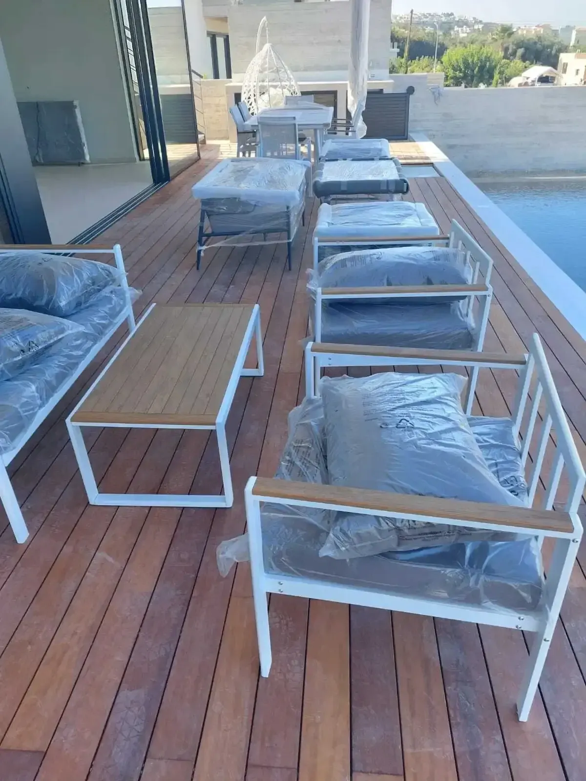 Finished timber deck with outdoor furniture beside the pool