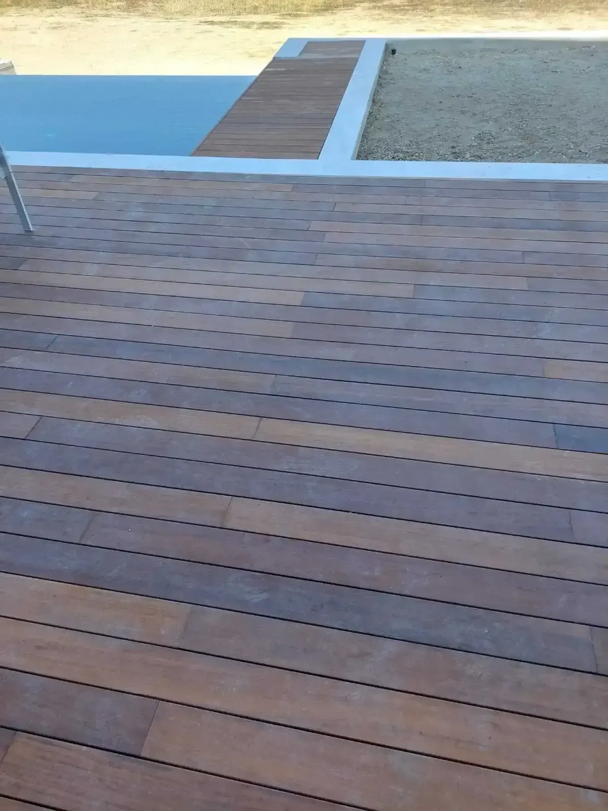 Decking boards finished neatly against the pool coping